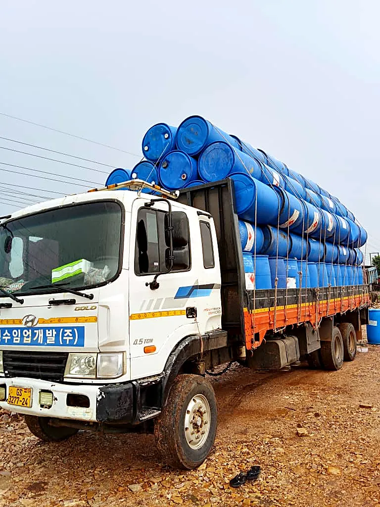 Truck loaded with blue drums used as cage floats